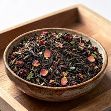 Load image into Gallery viewer, loose leaf black tea with rose petals and botanicals in ceramic bowl on wood tray
