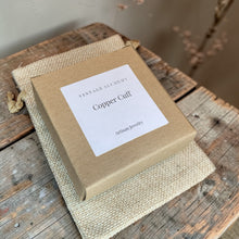 Load image into Gallery viewer, Vintage Alchemy magnetic copper cuff bracelet in kraft jewelry box on rustic wood surface artisan copper bracelet packaging
