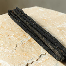 Load image into Gallery viewer, Wild Copal herb and resin incense sticks on natural stone surface with dark resin coating
