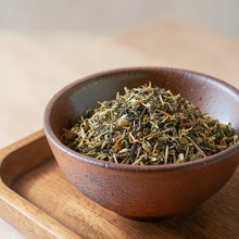 Load image into Gallery viewer, Loose leaf wild grape root green tea blend with botanicals in ceramic bowl on wooden tray
