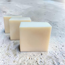 Load image into Gallery viewer, Three bars of Zest solid dish soap with pumice on a light stone surface. Lemon and lily scented dish soap handcrafted by Vintage Alchemy.
